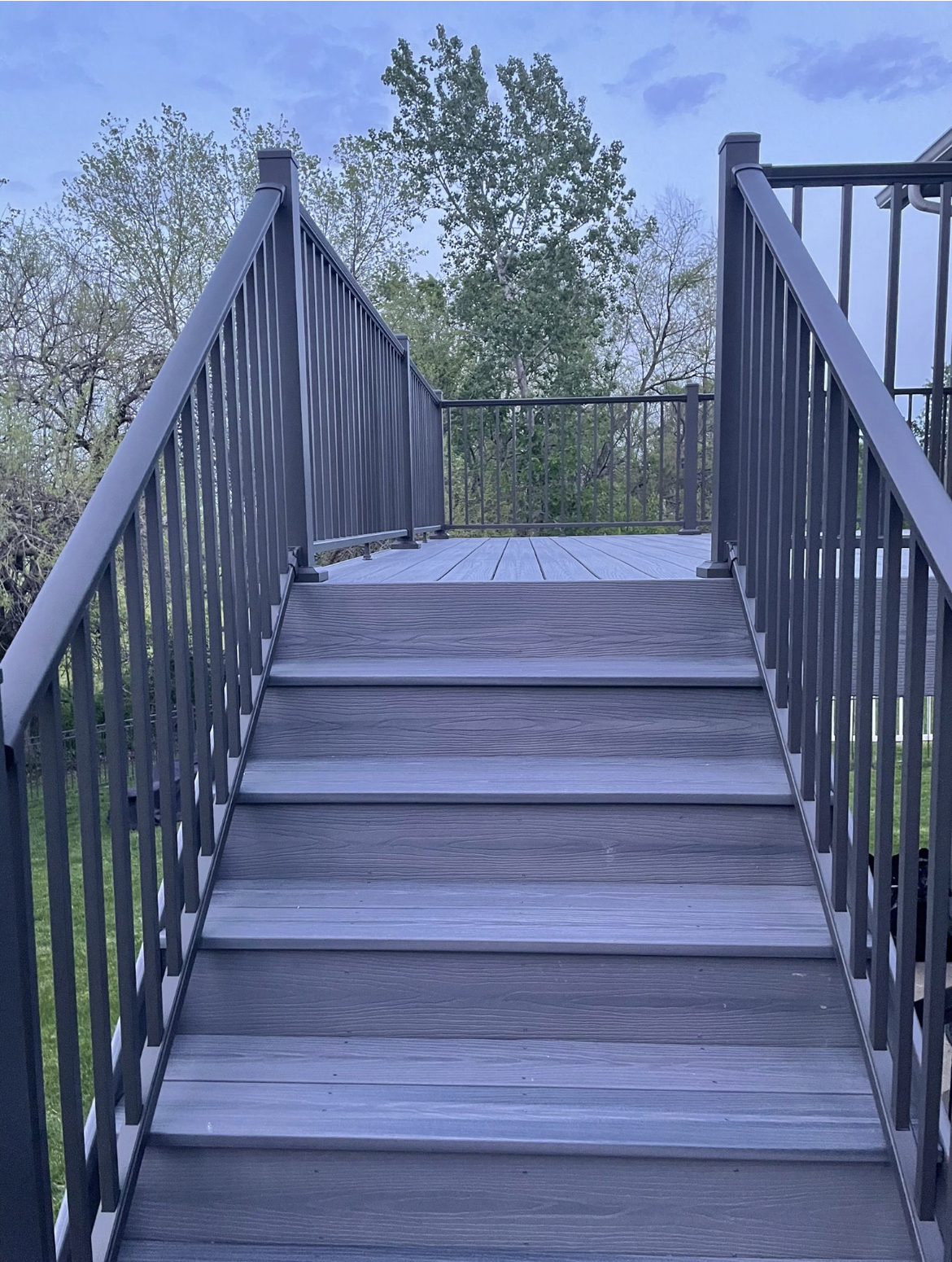 Gray composite deck stairs with matching aluminum railing