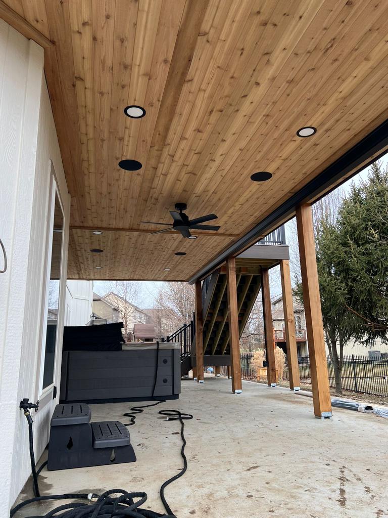 Under-deck cedar ceiling with recessed lights, fan and hot tub area