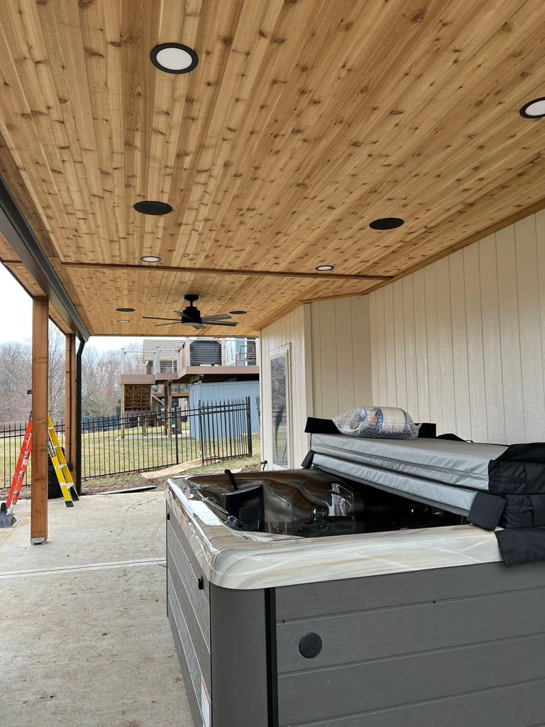 Covered patio with cedar tongue-and-groove ceiling, recessed lights and hot tub