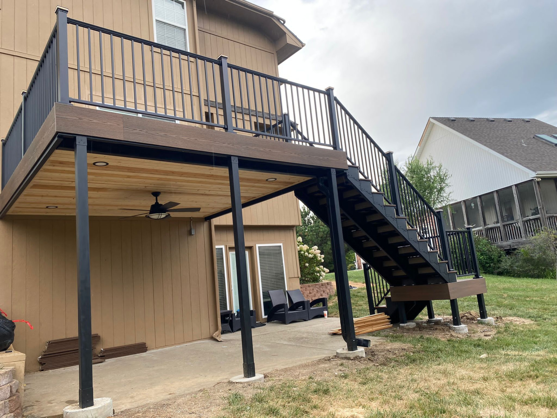Elevated composite deck with steel stairs and under-deck cedar ceiling